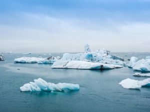 Serene view of icebergs floating in the calm waters of Jokulsarlon Lagoon, Iceland.